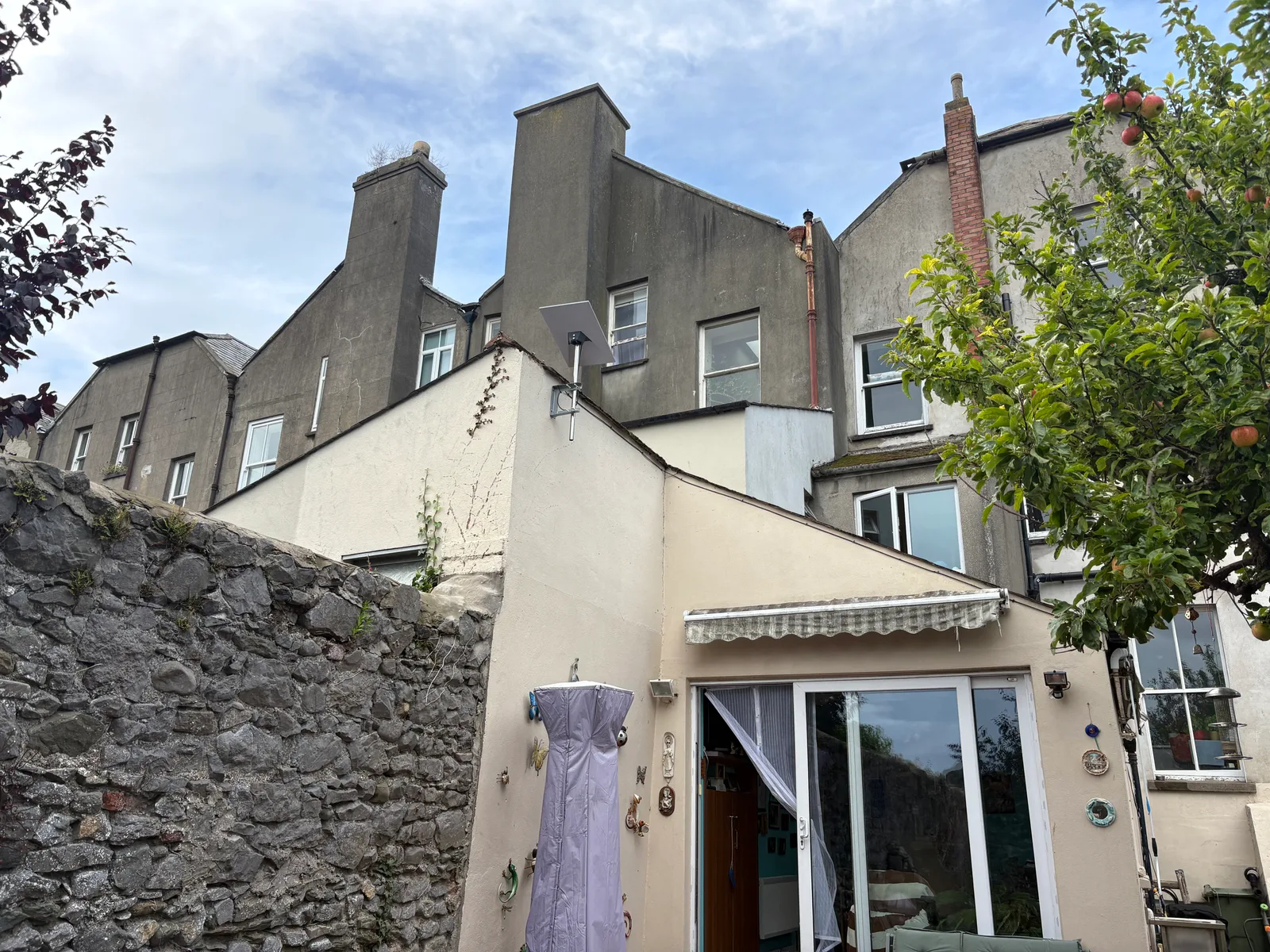 Starlink dish mounted on a bracket at the rear of Louis’s period home