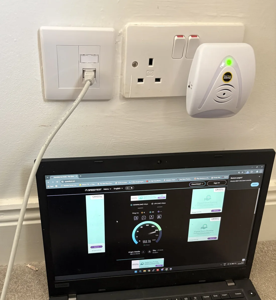 Laptop connected by an Ethernet cable to a wall socket at Niall’s home